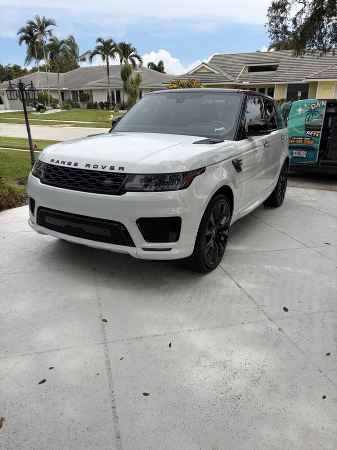 White Range Rover Sport detailed in the driveway, Dany's Detailing van on site